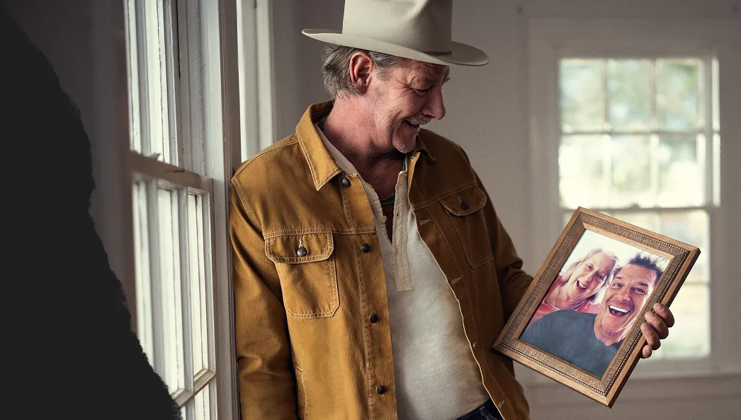 Ty Pennington holding a picture of him and his mom