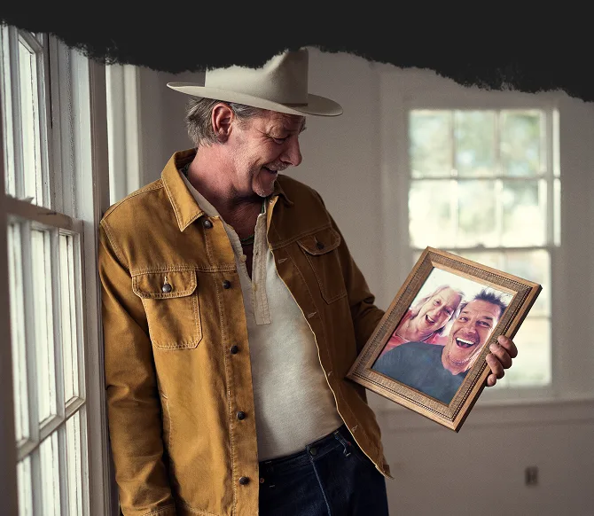 Ty Pennington holding a picture of him and his mom